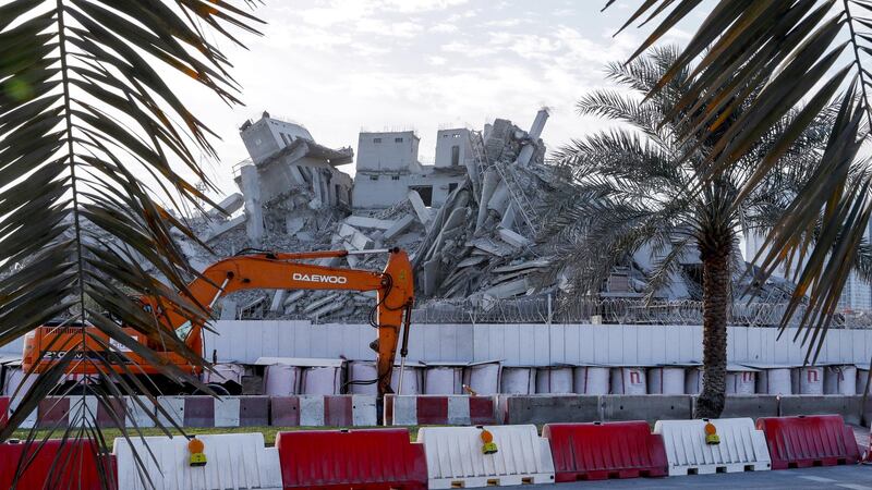 Excavator operating at the Mina Plaza demolition site